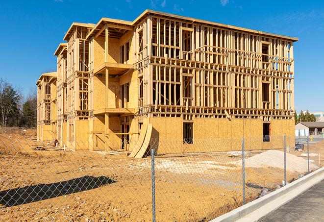 a close-up of temporary chain link fences enclosing a job site, signaling progress in the project's development in Sherman Oaks, CA